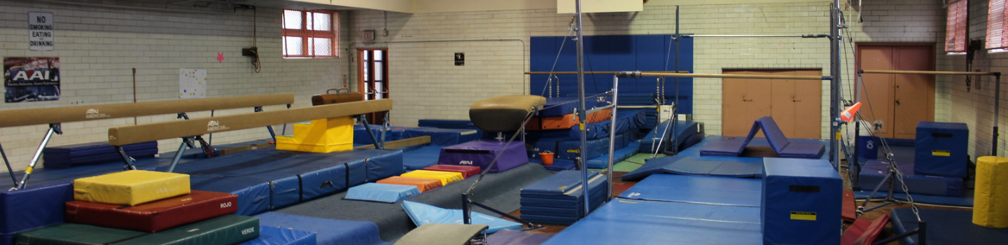 Gymnastics equipment set up in a gym.